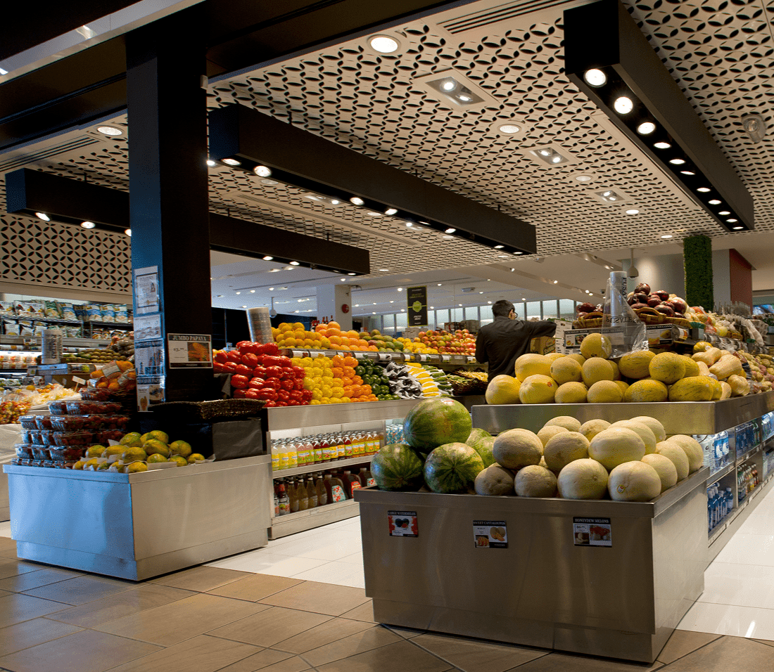 A large market with many fruits on display.