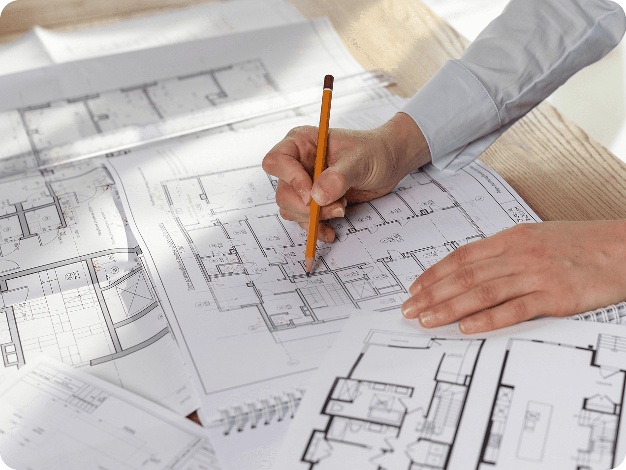 Architect drawing on building floor plans.