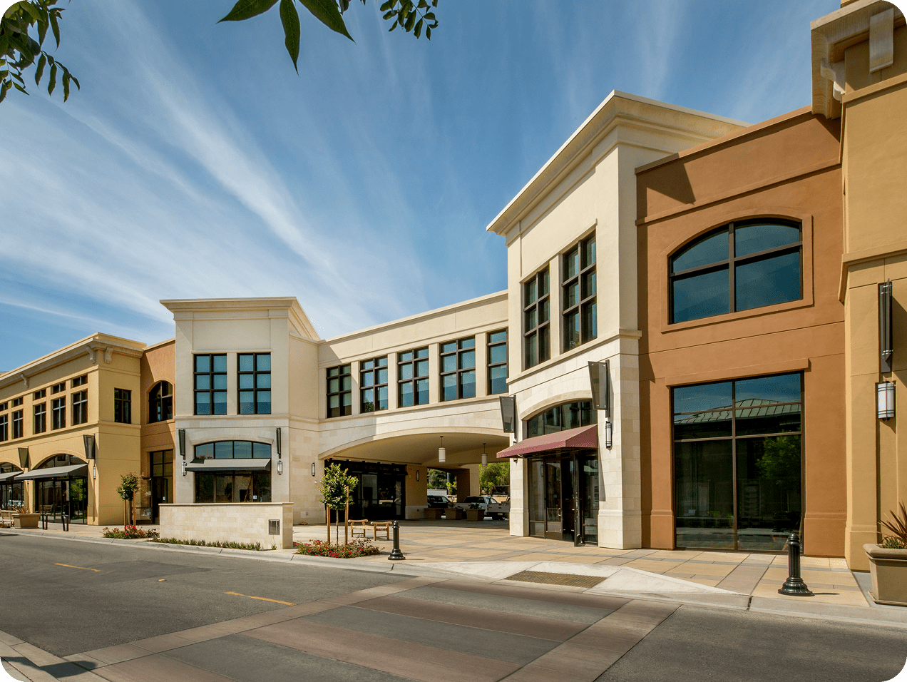 Modern shopping center with clear blue sky.