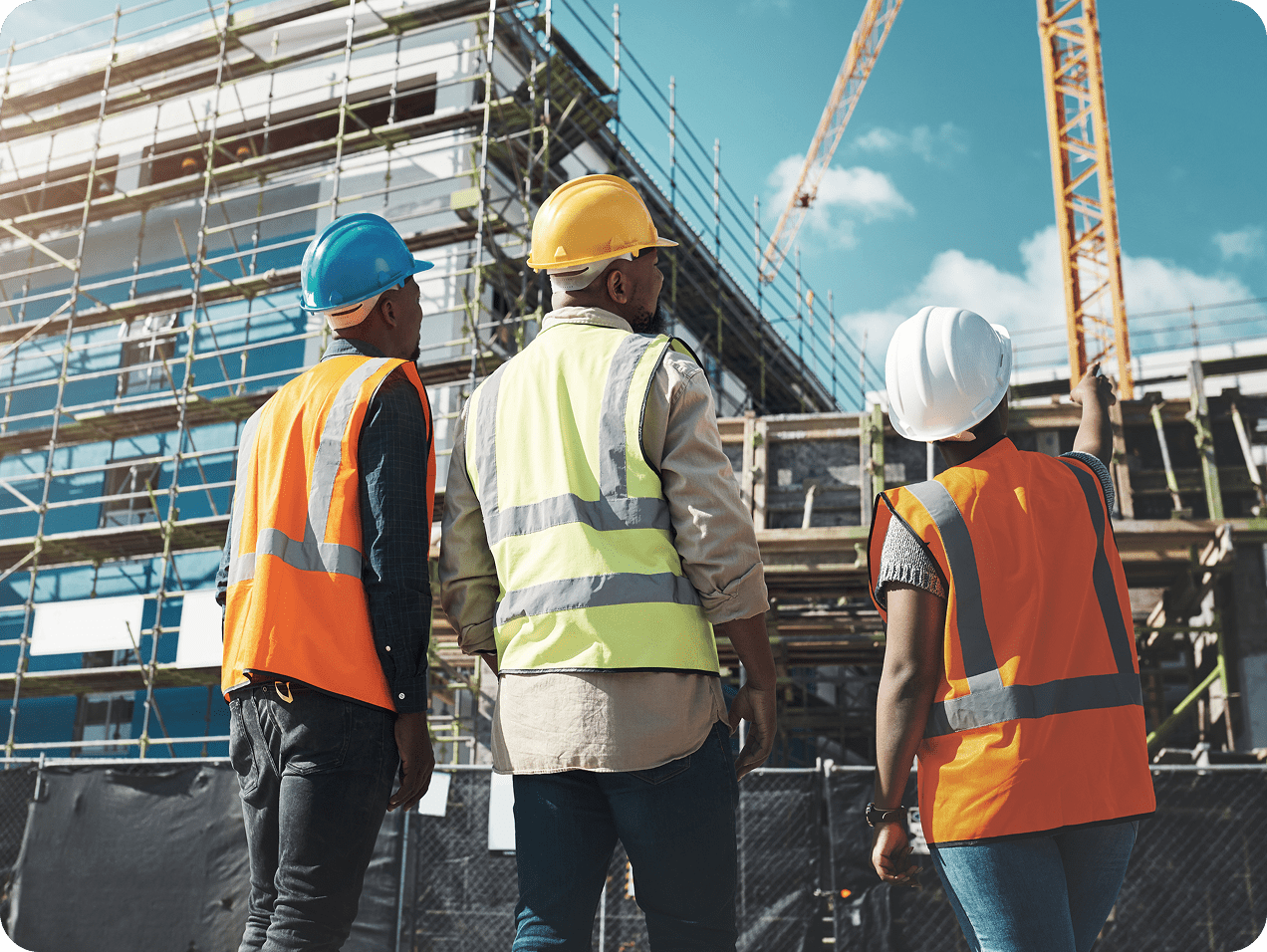 Construction workers observing building progress site.