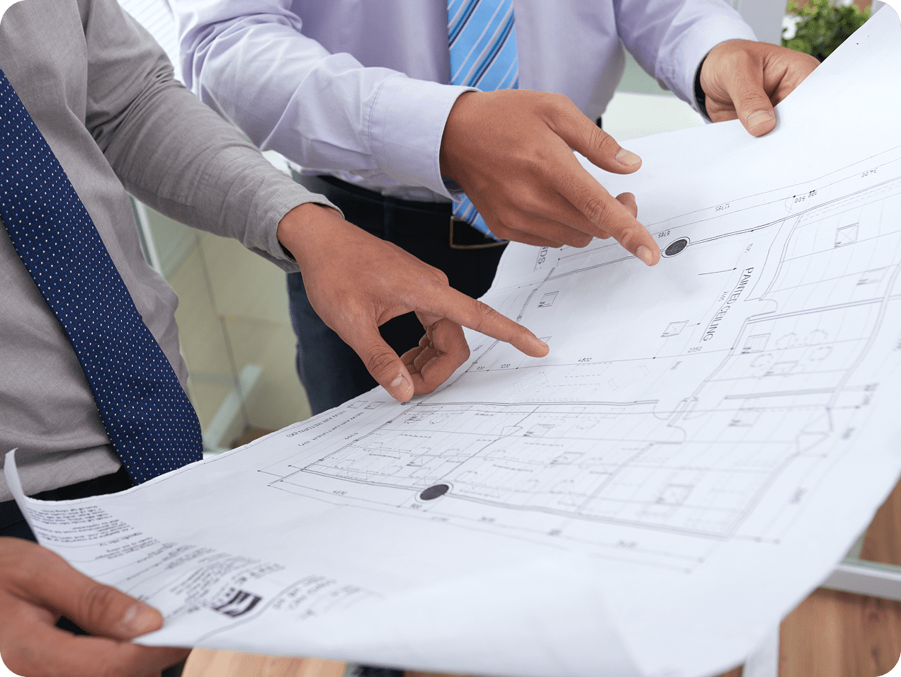Two people examining a building blueprint.