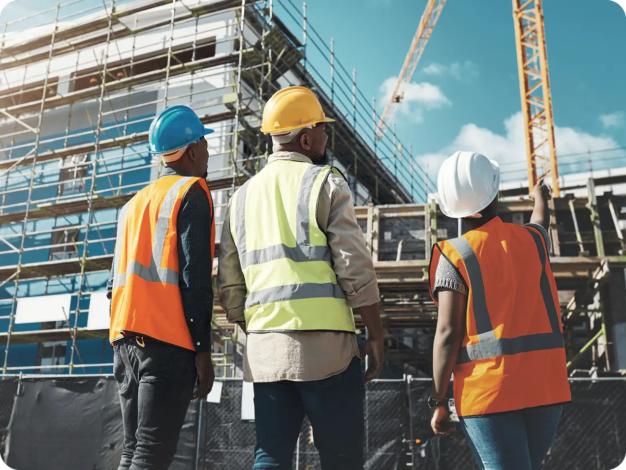 Team inspecting scaffolding and crane